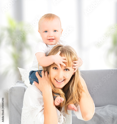 happy family. baby sits astride the shoulders of the mother