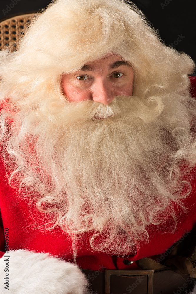 Santa Claus sitting in a comfortable rocking chair near the Chri Santa Claus sitting in a comfortable rocking chair near the Chri