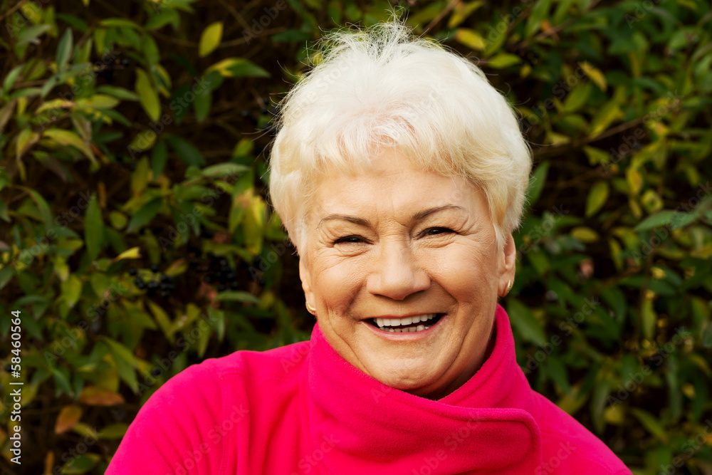 Portrait of a cheerful old lady over green background. Portrait of a cheerful old lady over green background.