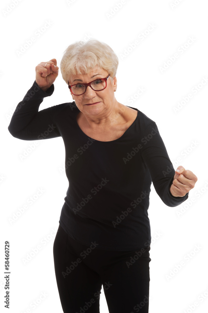Attractvie old woman with closed fists. Attractvie old woman with closed fists.