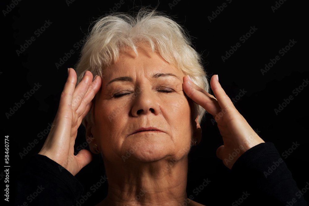 An old lady having a headache. An old lady having a headache.