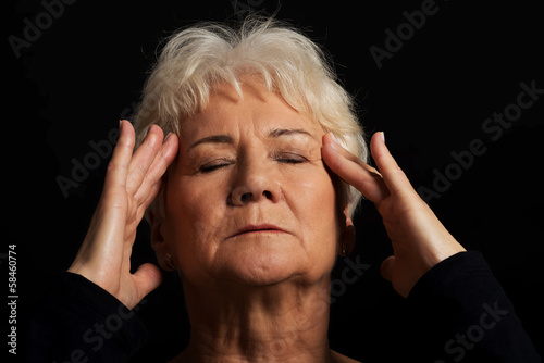 An old lady having a headache.