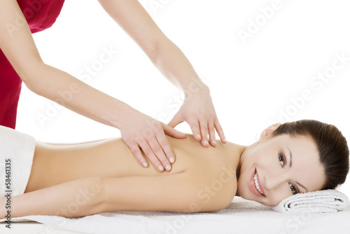 Preaty woman relaxing being massaged in spa saloon.