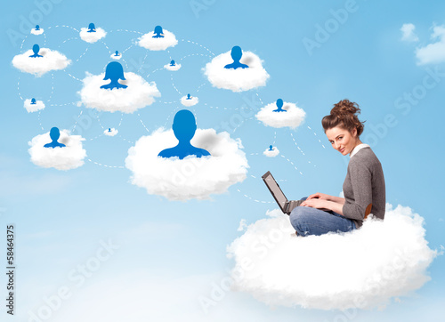 Young woman sitting in cloud with laptop © ra2 studio