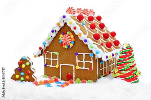 Gingerbread house in snow isolated on white