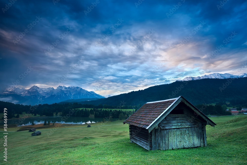 wooden hut by Geroldsee lake during sunrise