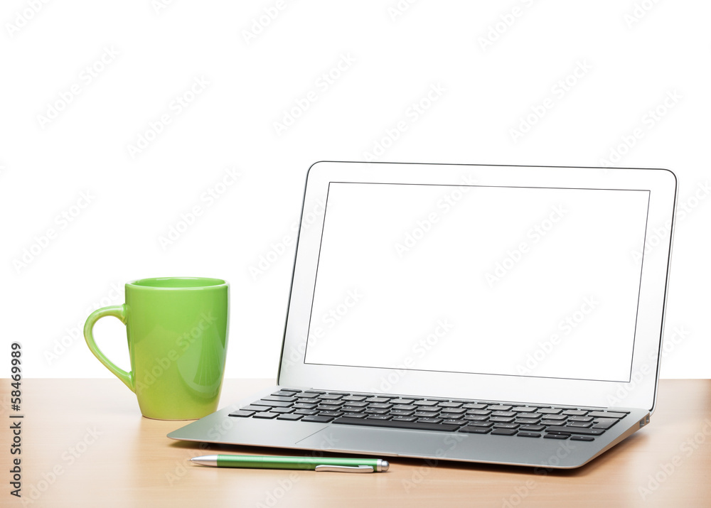 Laptop with blank screen and cup on table Laptop with blank screen and cup on table