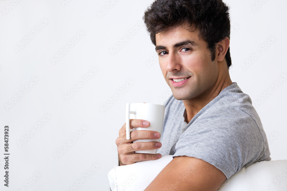 Happy young man with a steamy cup of coffee Happy young man with a steamy cup of coffee