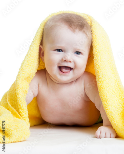 Adorable happy baby in towel