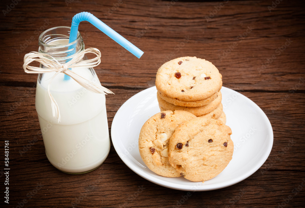 cookies and bottle milk on wood table cookies and bottle milk on wood table