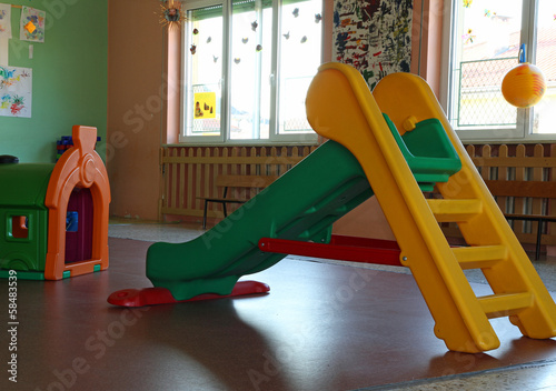 plastic chute green and yellow in the playroom inside the asylum photo