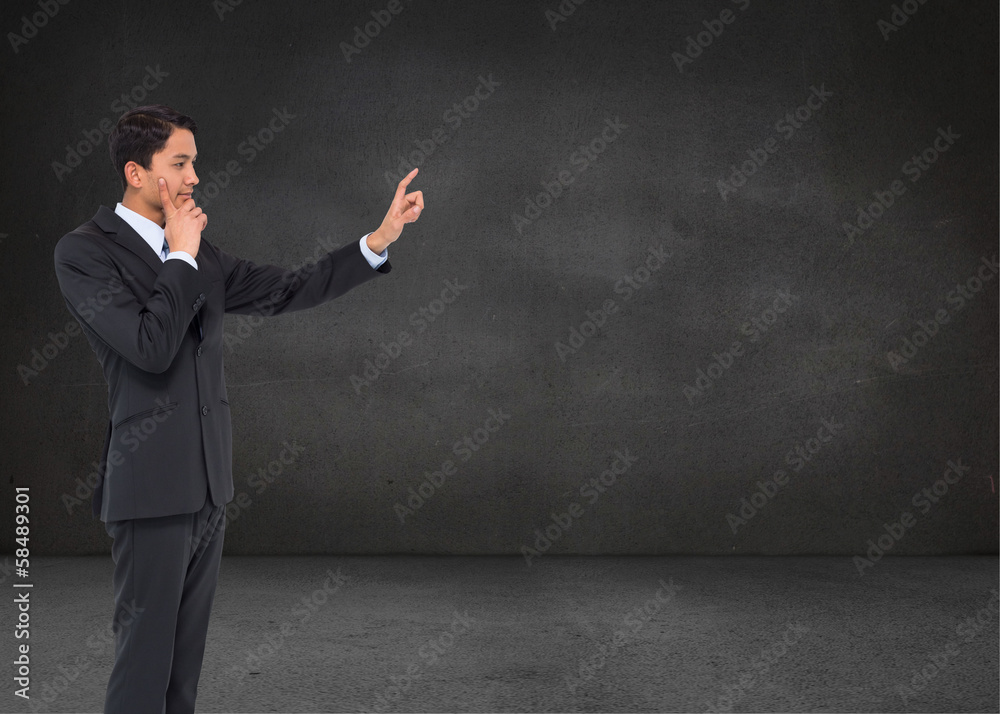 Composite image of thoughtful asian businessman pointing Composite image of thoughtful asian businessman pointing
