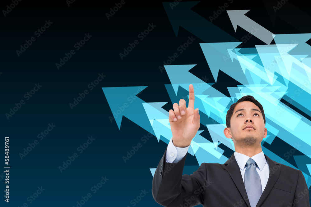 Composite image of serious asian businessman pointing