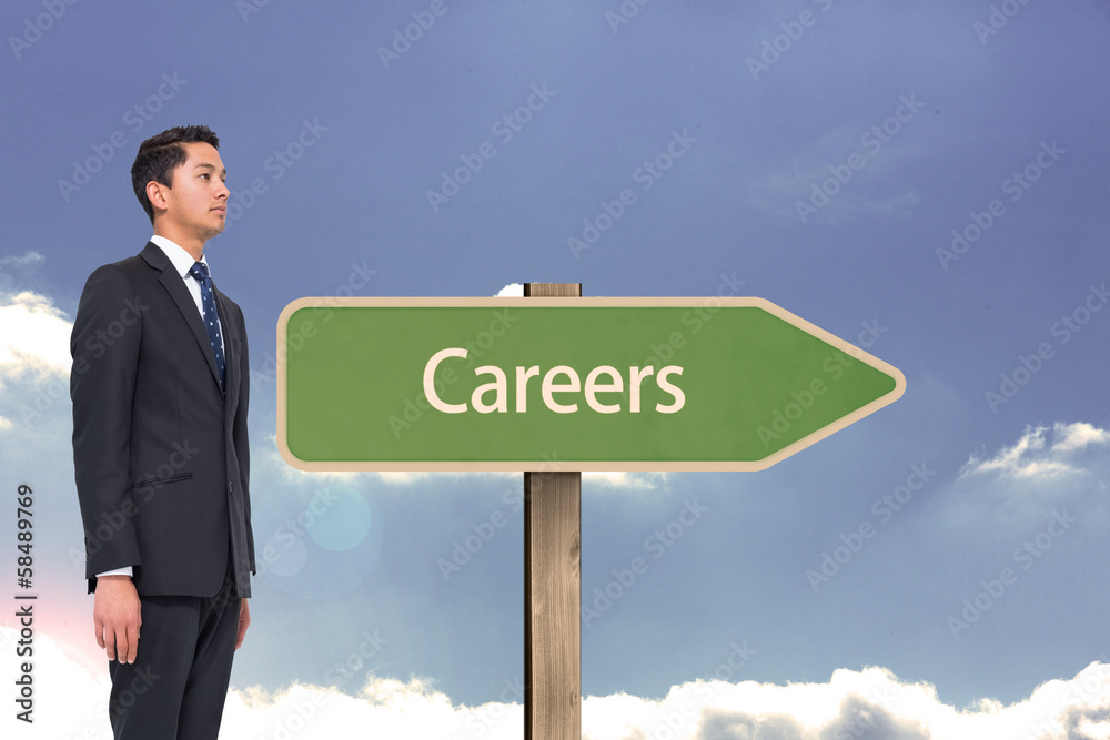 Composite image of serious businessman looking up Composite image of serious businessman looking up