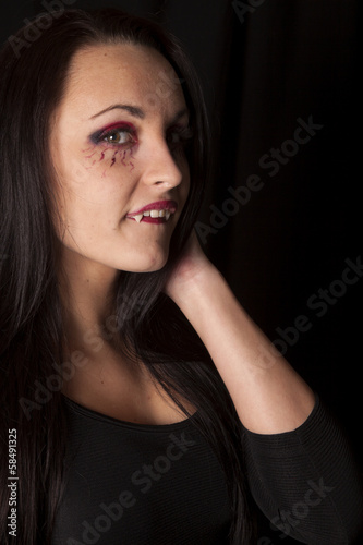 woman vampire show fangs