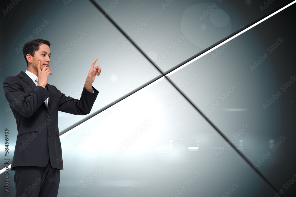 Composite image of thoughtful asian businessman pointing Composite image of thoughtful asian businessman pointing
