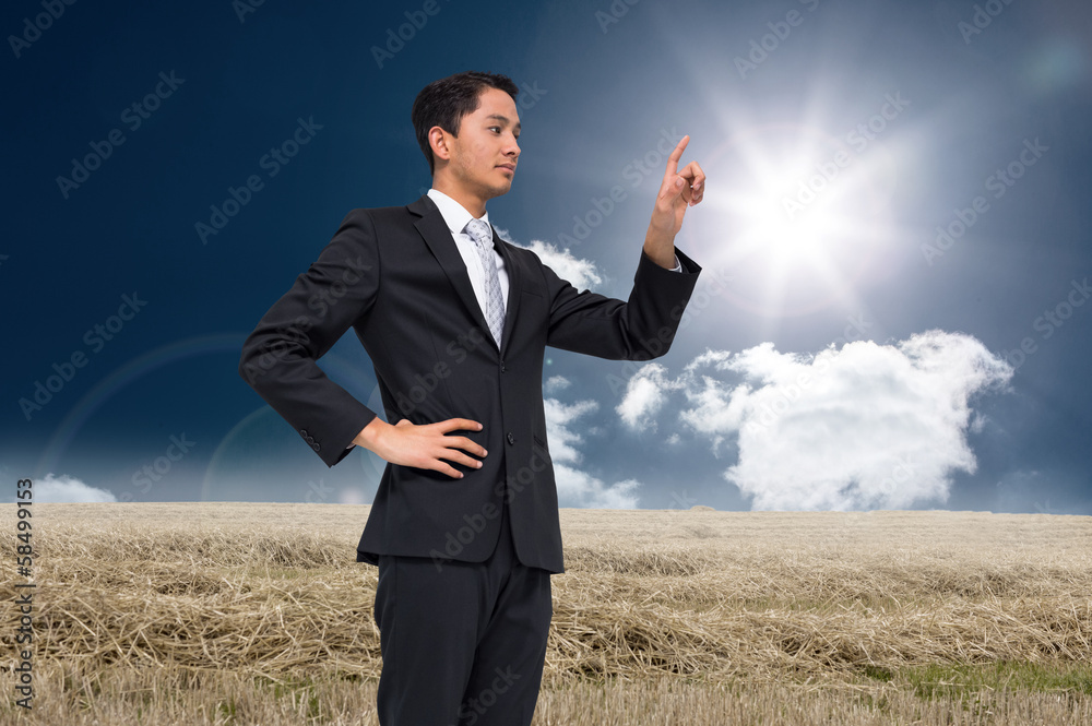 Composite image of unsmiling asian businessman pointing Composite image of unsmiling asian businessman pointing