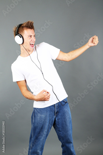 Handsome young man listenin...
