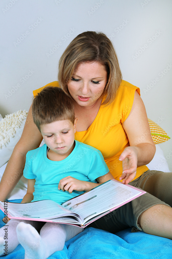 Little boy with mom read book in bed Little boy with mom read book in bed