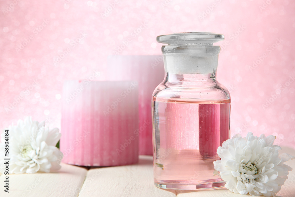Glass bottle with color essence, on pink background