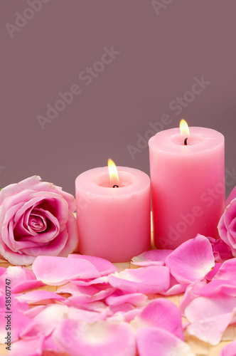 Lying down rose with candle and petals on mat