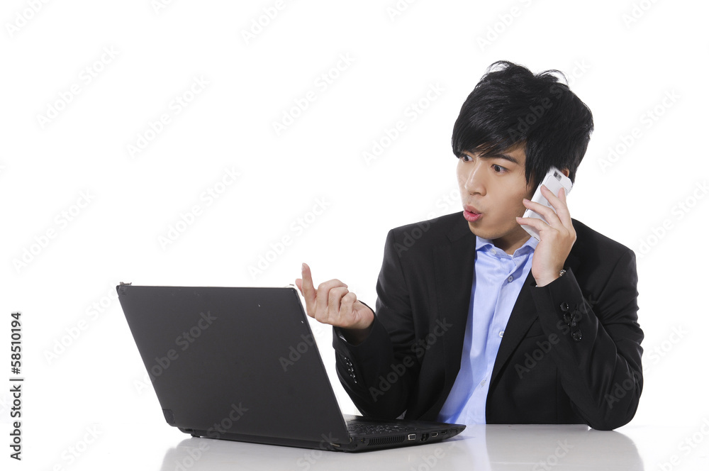 business man speaking on cellphone and working on laptop business man speaking on cellphone and working on laptop