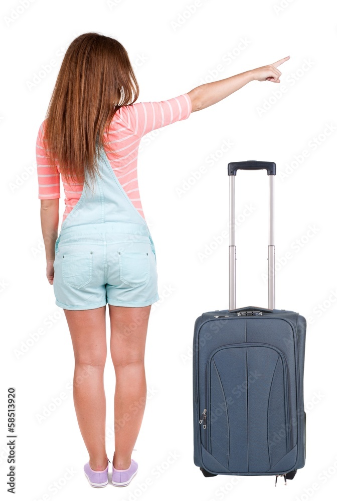 Back view of traveling pointing woman with suitcase Back view of traveling pointing woman with suitcase