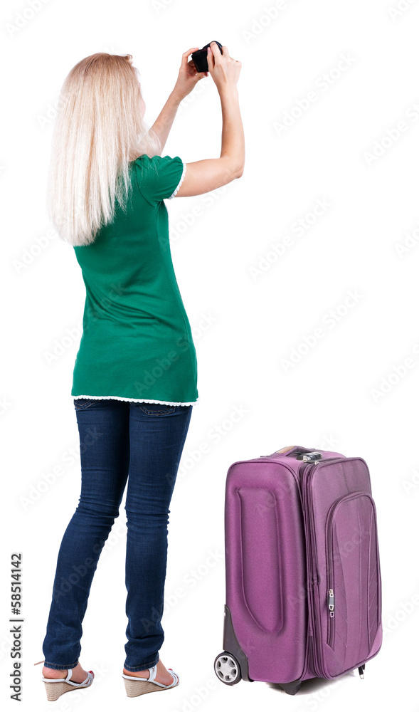 Back view of woman photographing traveling with suitcas. Back view of woman photographing traveling with suitcas.