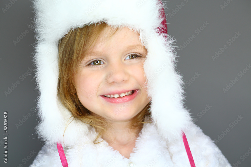 Portrait of little girl in winter hat with white fur Portrait of little girl in winter hat with white fur