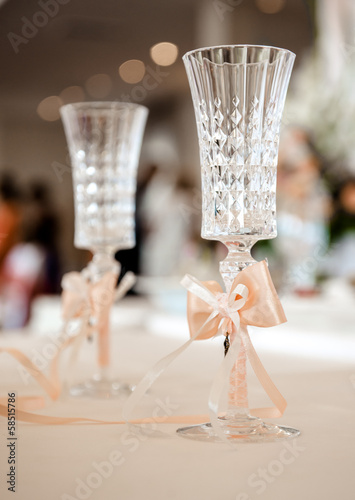 Champagne glasses decorated with orange bows