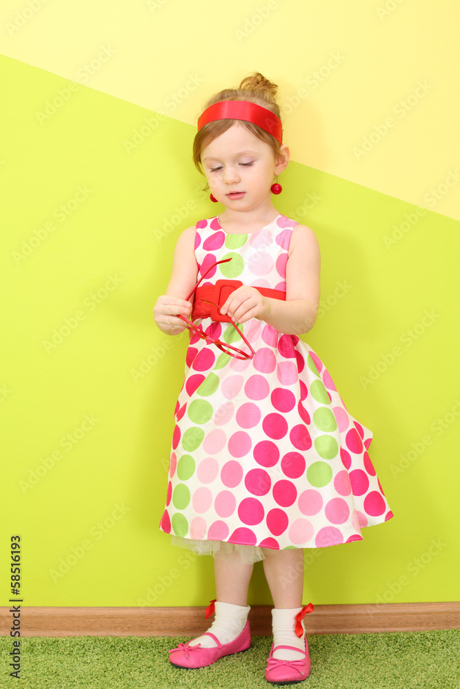A little girl in a bright varicolored dress A little girl in a bright varicolored dress