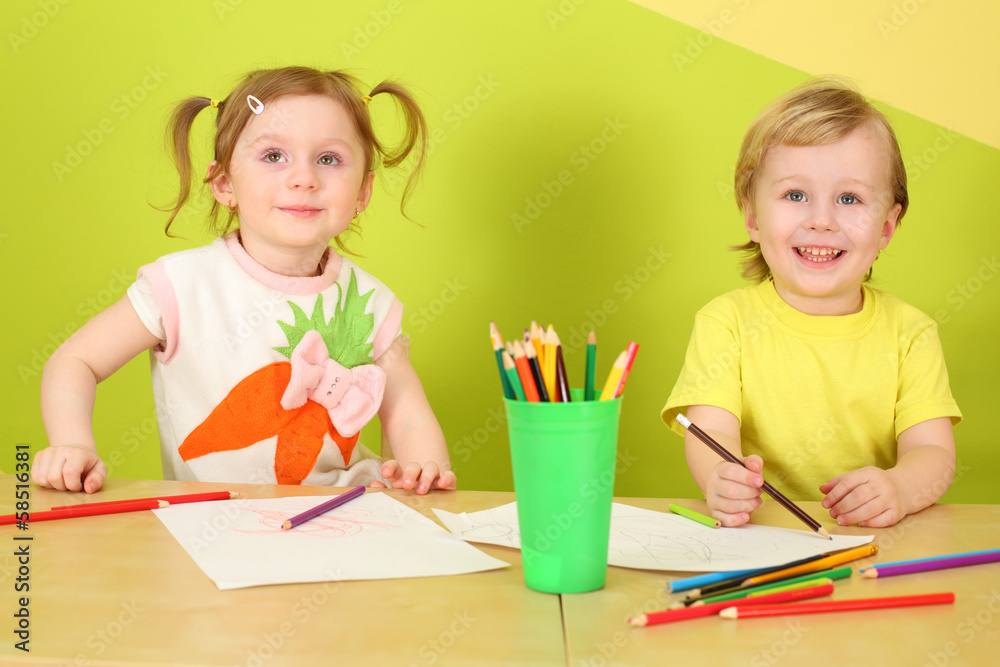 Little boy and girl draw with colored pencils Little boy and girl draw with colored pencils