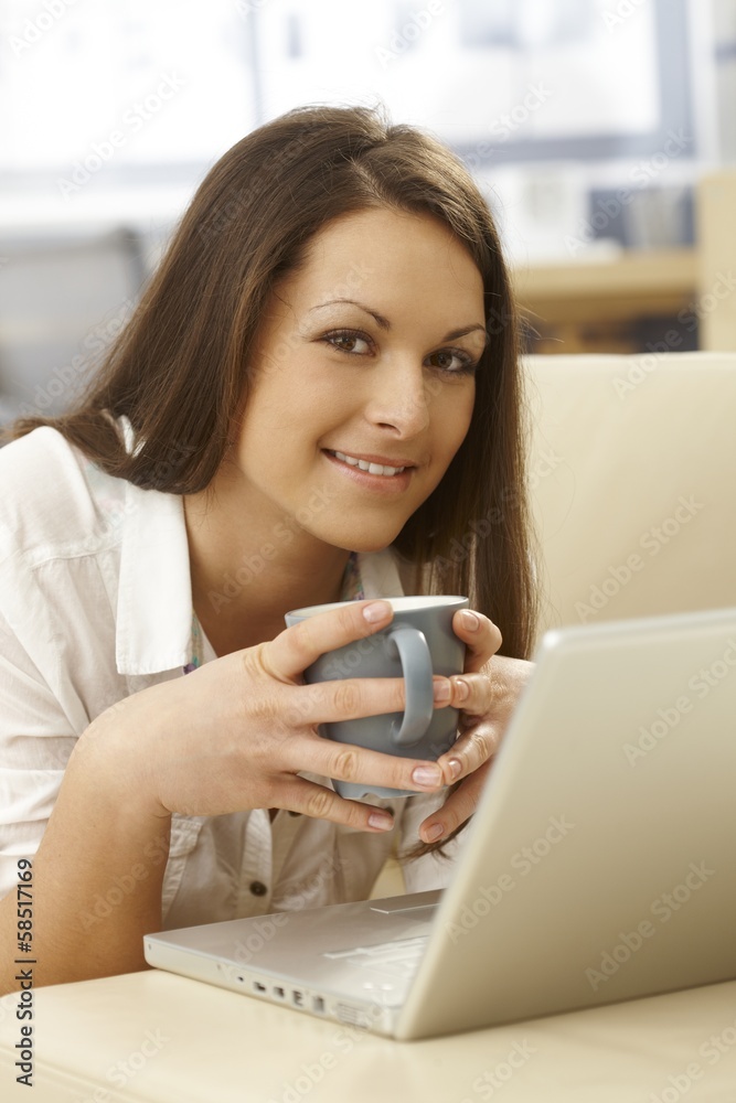 Portrait of happy woman with tea and laptop Portrait of happy woman with tea and laptop