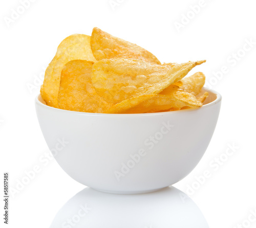 Appetizing golden chips in faience bowl