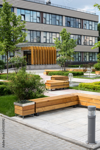 Modern Business Center with green trees, benches and fountains photo