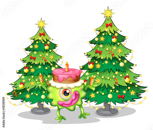 A one-eyed monster celebrating a birthday near the christmas tre