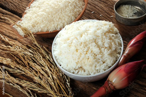 cooked rice, uncooked rice and paddy rice on wooden tabel
