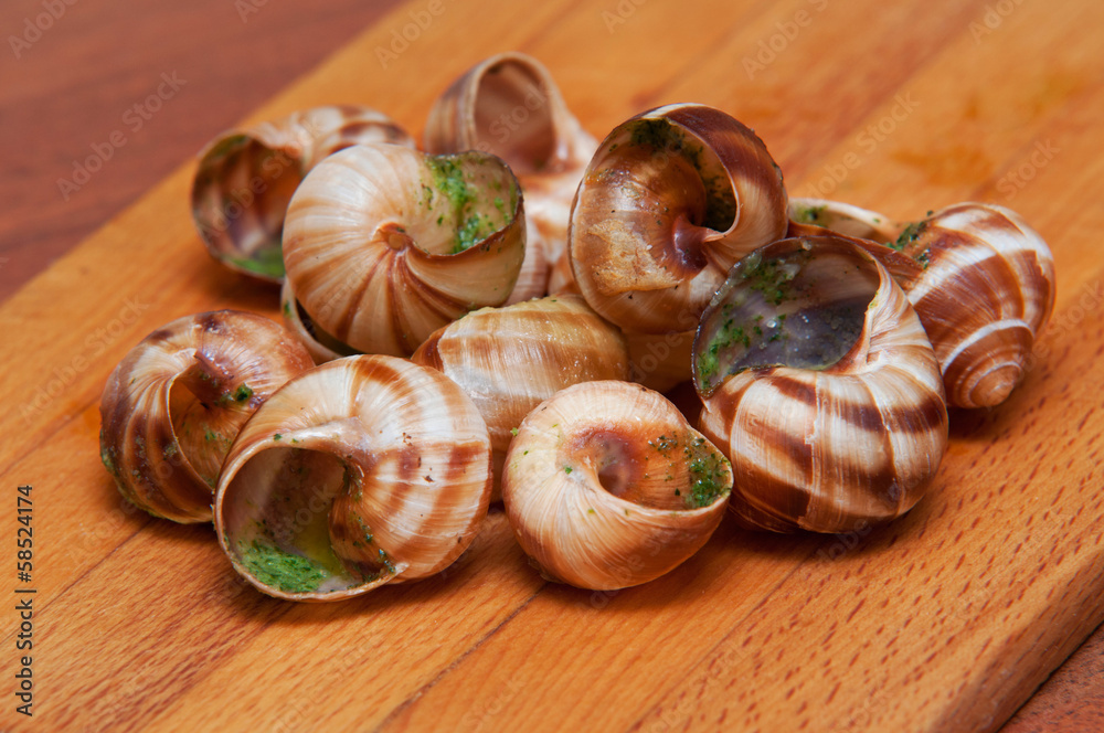 Closeup of empty baked snails with garlic butter Closeup of empty baked snails with garlic butter