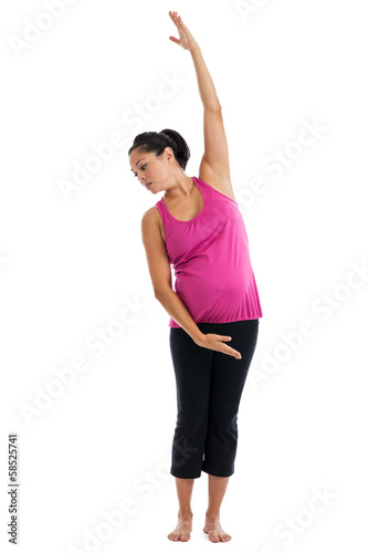 Beautiful fit pregnant woman doing side stretch
