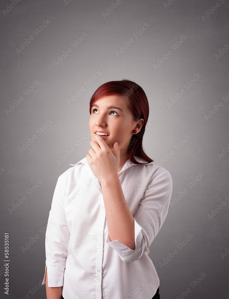 Young woman standing and thinking with copy space Young woman standing and thinking with copy space
