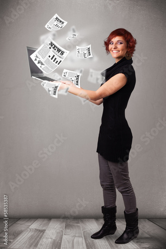 Casual young woman holdin notebook and reading the explosive new