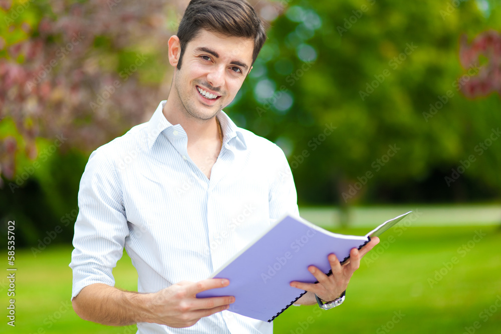 Young student reading a book