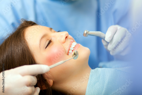 Female patient having a treatment at the dentist