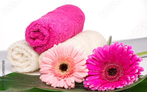 Spa still life with aromatic candles, flower and towel