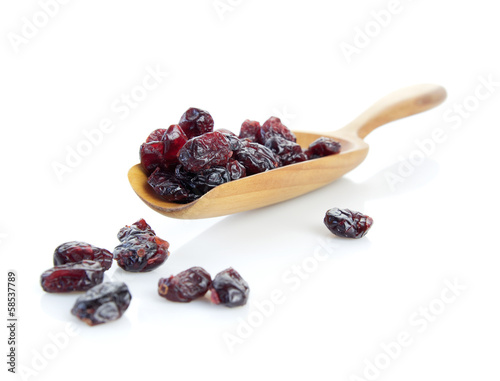 Dried cranberry in a wooden scoop