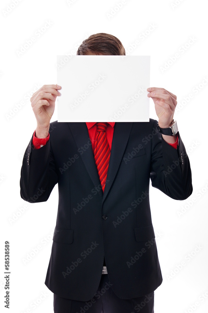 Young business man in suit holds paper before the head. Young business man in suit holds paper before the head.