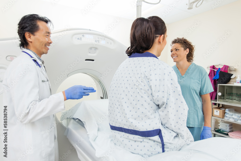 Medical Team With Patient In CT Scan Room Medical Team With Patient In CT Scan Room