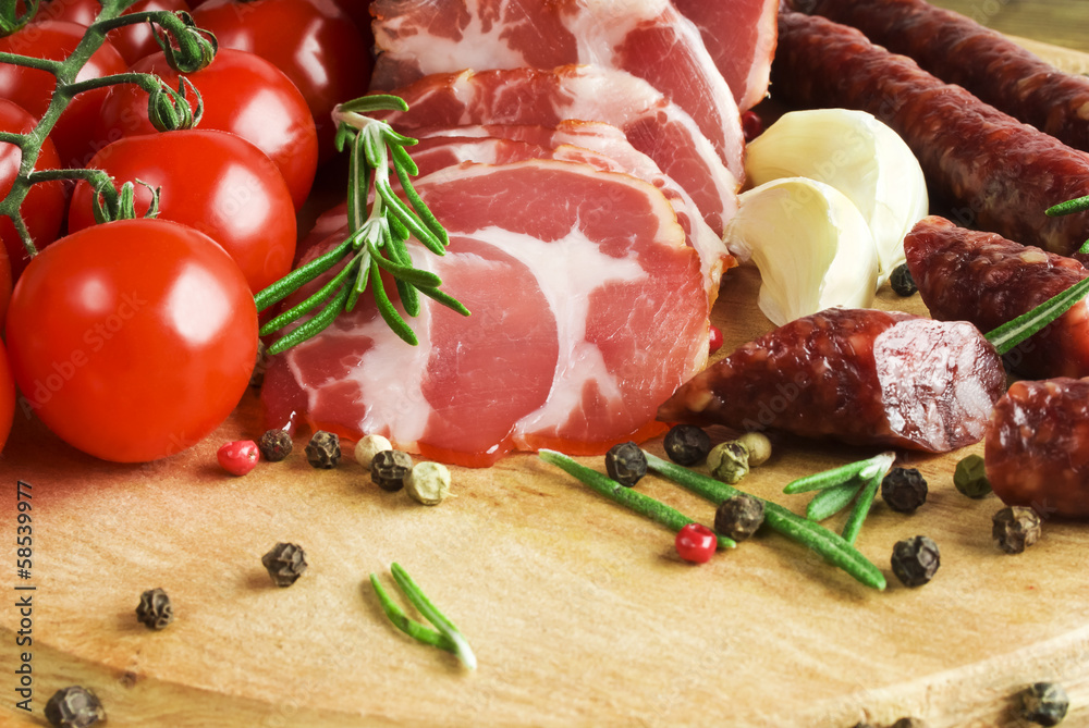 Sliced Smoked Ham and Smoked sausage with rosemary Sliced Smoked Ham and Smoked sausage with rosemary