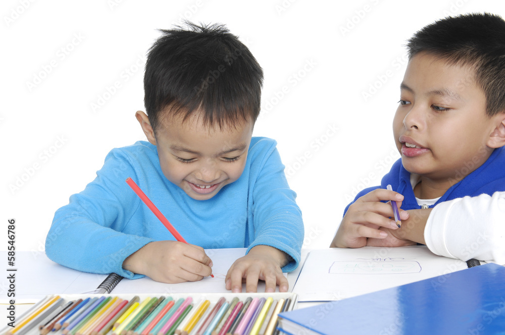 Brother School boy setting and writing in notebook Brother School boy setting and writing in notebook