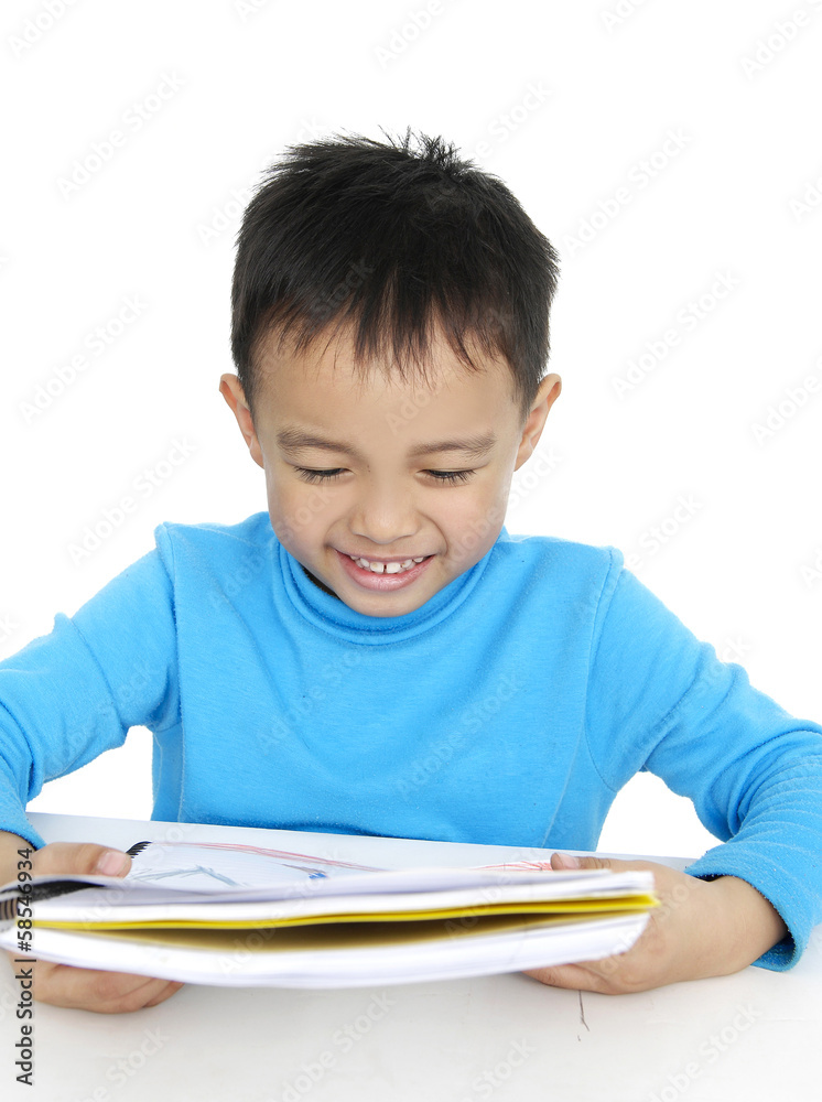 Portrait of a schoolboy sitting at table with books Portrait of a schoolboy sitting at table with books